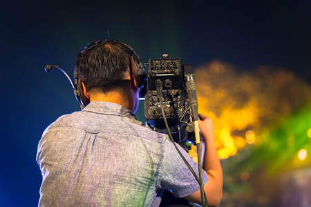 Back view of professional television camera in event at night.の写真素材