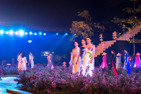 Hanoi, Vietnam - Oct 15, 2016: Vietnamese girls wear traditional dress is Ao Dai on stage at festival at Imperial Citadel of Thang Longのeditorial素材