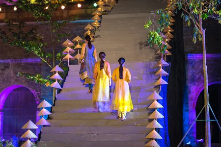 Hanoi, Vietnam - Oct 15, 2016: Vietnamese girls wear traditional dress is Ao Dai on stage at festival at Imperial Citadel of Thang Longのeditorial素材