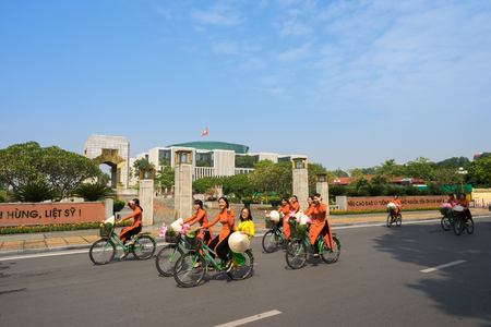 Hanoi, Vietnam - Oct 16, 2016: Vietnamese girls wear traditional long dress Ao Dai cycling on Hanoi streetのeditorial素材