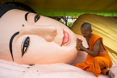 Ca Mau, Vietnam - Dec 6, 2016: Novices washing lying Buddha statue at Khmer Monivongsa Bopharam...