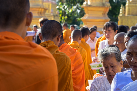 An Giang, Vietnam - Dec 6, 2016: Buddhist monk in south of Vietnam stand in a row waiting people put rice and food offerings in their alms bowlのeditorial素材
