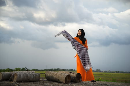 An Giang, Vietnam - Sep 6, 2016: Portrait of Vietnamese muslim girl dancing with scarf in a champa village, Khanh Hoan district, South Vietnamのeditorial素材