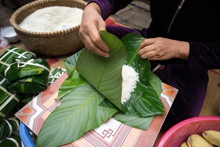 Making Chung cake by female craftsman closeup. Traditional Vietnamese New Year (Tet) food.の写真素材