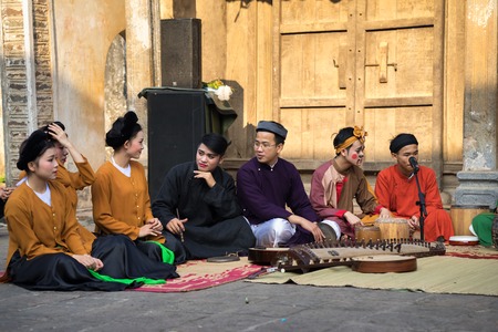 Hanoi, Vietnam - Jun 22, 2017: Folk music band sitting on courtyard of communal house at So village,...
