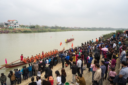 Bac Ninh, Vietnam - Feb 7, 2017: Cheering audiences at traditional boat racing spring festival on...