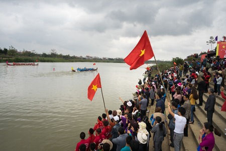 Bac Ninh, Vietnam - Feb 7, 2017: Cheering audiences at traditional boat racing spring festival on...