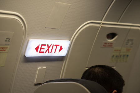 Close up of exit sign in passenger airplane.の写真素材