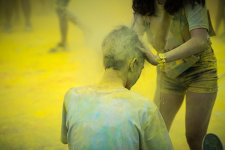 Color dust in hair of a runner in color run event