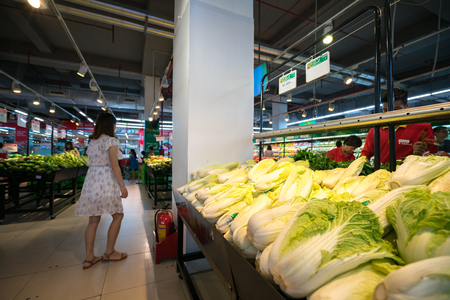 Hanoi, Vietnam - July 10, 2017: Organic vegetables on shelf in Vinmart supermarket, Minh Khai street.のeditorial素材