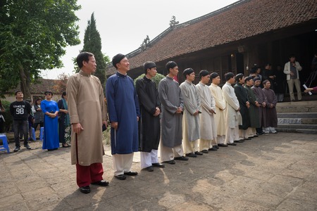 Hanoi, Vietnam - Jun 22, 2017: Vietnamese men wear traditional long dress Ao Dai standing at ancient village in communal house at So village, Quoc Oai district.のeditorial素材