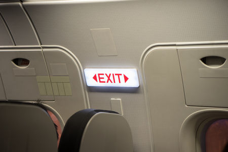 Close up of exit sign in passenger airplane.の写真素材