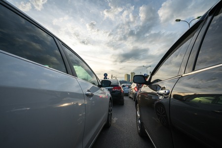 Cars on city street in traffic jam at rush hourの写真素材