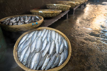 Boiled fish basket. Seafood processing at fish market in Quy Nhon, south Vietnamの写真素材
