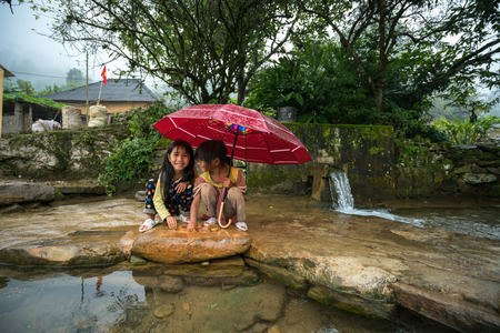 Lao Cai, Vietnam - Sep 7, 2017: Ethnic minority children playing at small spring in Y Ty, Bat Xat districtのeditorial素材