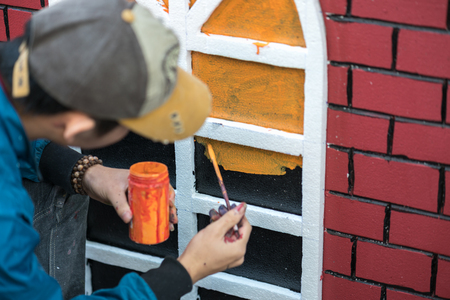 Man painting play house made of styrofoam closeupの写真素材