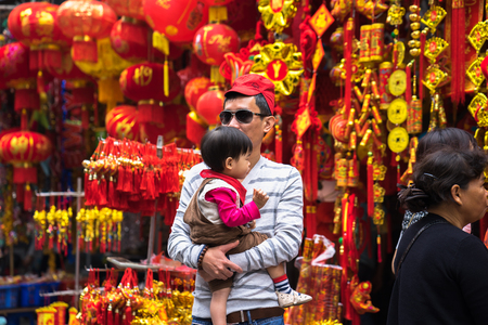 Hanoi, Vietnam - Jan 26, 2017: People take a walk buying decoration and flower for Vietnamese lunar new year on Hang Ma streetのeditorial素材