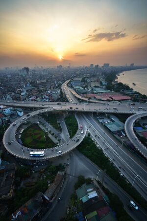 Hanoi, Vietnam - June 5, 2017: Aerial view of Hanoi cityscape by twilight period, with road junction and interchange overpass Vinh Tuy bridge - Minh Khai street - Nguyen Khoai streetのeditorial素材