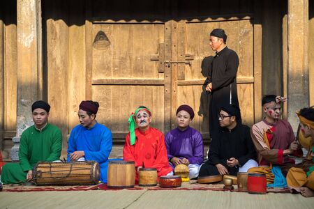Hanoi, Vietnam - Jun 22, 2017: Folk music band sitting on courtyard of communal house at So village, Quoc Oai district,のeditorial素材