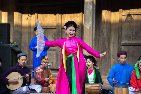 Hanoi, Vietnam - Jun 22, 2017: An act of folk music and dance called Thi Mau visits temple, the most popular act of Cheo in Vietnam, on courtyard of communal house at So village, Quoc Oai district,のeditorial素材