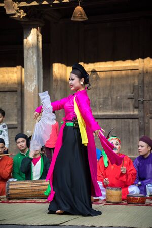 Hanoi, Vietnam - Jun 22, 2017: An act of folk music and dance called Thi Mau visits temple, the most popular act of Cheo in Vietnam, on courtyard of communal house at So village, Quoc Oai district,のeditorial素材
