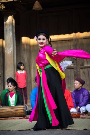 Hanoi, Vietnam - Jun 22, 2017: An act of folk music and dance called Thi Mau visits temple, the most popular act of Cheo in Vietnam, on courtyard of communal house at So village, Quoc Oai district,のeditorial素材