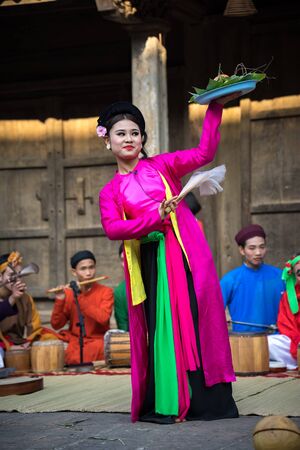 Hanoi, Vietnam - Jun 22, 2017: An act of folk music and dance called Thi Mau visits temple, the most popular act of Cheo in Vietnam, on courtyard of communal house at So village, Quoc Oai district,のeditorial素材