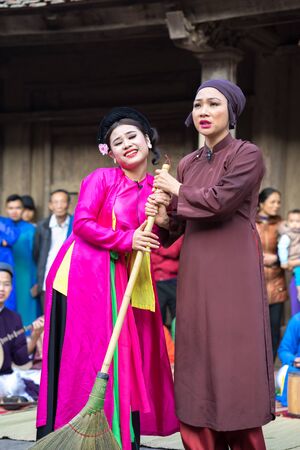 Hanoi, Vietnam - Jun 22, 2017: An act of folk music and dance called Thi Mau visits temple, the most popular act of Cheo in Vietnam, on courtyard of communal house at So village, Quoc Oai district,のeditorial素材