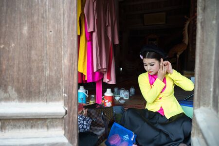 Hanoi, Vietnam - Jun 22, 2017: Actress making up before a traditional operetta in communal house at So village, Quoc Oai district.のeditorial素材