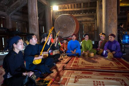 Hanoi, Vietnam - Jun 22, 2017: Traditional folk singer performing a folk song in communal house at So village, Quoc Oai district.のeditorial素材