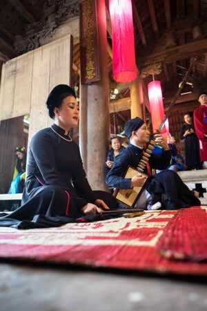 Hanoi, Vietnam - Jun 22, 2017: Traditional folk singer performing a folk song in communal house at So village, Quoc Oai district.のeditorial素材