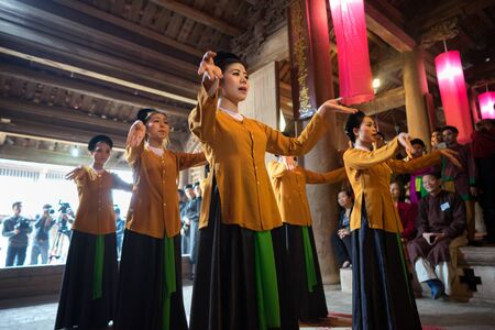 Hanoi, Vietnam - Jun 22, 2017: Dancers dancing with traditional folk music in communal house at So village, Quoc Oai district.のeditorial素材