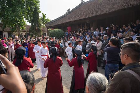 Hanoi, Vietnam - Jun 22, 2017: Dancers dancing with traditional folk music in communal house at So village, Quoc Oai district.のeditorial素材