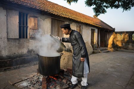 Hanoi, Vietnam - Jun 22, 2017: Cooking Chung cake outdoor in communal house at So village, Quoc Oai district. Square glutinous rice cake, Vietnamese lunar new year foodのeditorial素材