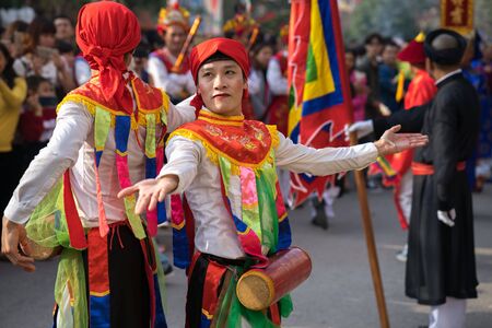 Hanoi, Vietnam - Feb 5, 2017: Men with women dress performing ancient dance called Con Di Danh Bong - Prostitutes beat the drum at spring festival in Trieu Khuc village.のeditorial素材