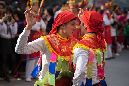 Hanoi, Vietnam - Feb 5, 2017: Men with women dress performing ancient dance called Con Di Danh Bong - Prostitutes beat the drum at spring festival in Trieu Khuc village.のeditorial素材