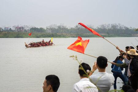 Bac Ninh, Vietnam - Feb 7, 2017: Cheering audiences at traditional boat racing spring festival on Cau river, Bac Ninh provinceのeditorial素材