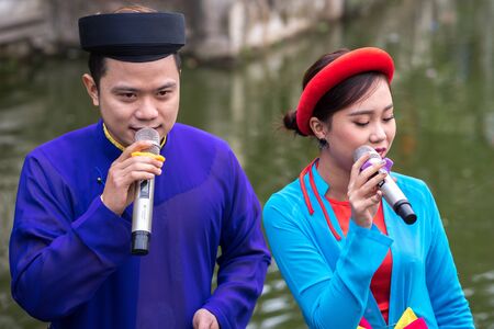 Hanoi, Vietnam - Feb 9, 2017: Folk singers singing Bac Ninh duets, folk singing on the boat in La Phu village, Hoai Duc. Intangible Heritage of Humanity.のeditorial素材