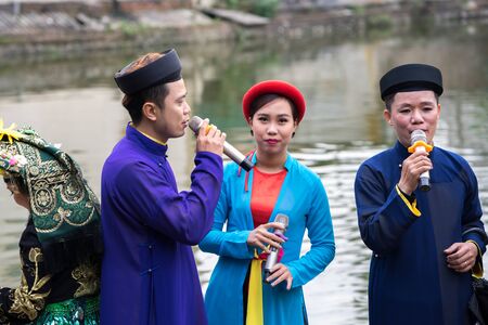 Hanoi, Vietnam - Feb 9, 2017: Folk singers singing Bac Ninh duets, folk singing on the boat in La Phu village, Hoai Duc. Intangible Heritage of Humanity.のeditorial素材