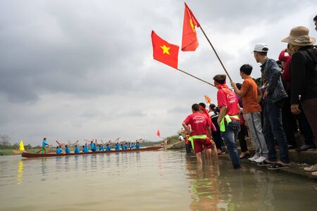 Bac Ninh, Vietnam - Feb 7, 2017: Cheering audiences at traditional boat racing spring festival on Cau river, Bac Ninh provinceのeditorial素材
