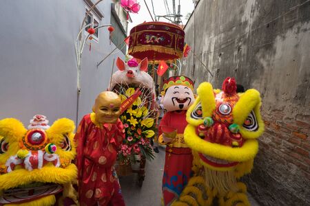 Hanoi, Vietnam - Feb 9, 2017: Pig procession festival in La Phu village. People wearing formal uniform and going from the main path of the village to the temple.のeditorial素材