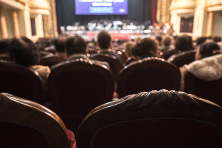 Blurred Audience in a theater, on a concert. Viewers watching the show.の写真素材