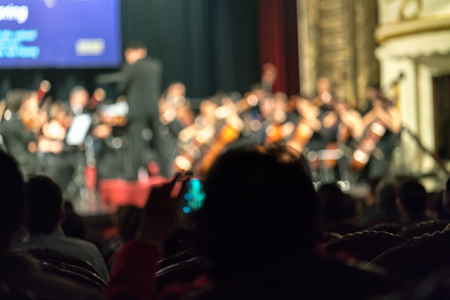 Blurred Audience in a theater, on a concert. Viewers watching the show.の写真素材