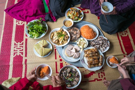 A traditional Vietnamese meal for lunar new year Tet holiday in spring, placed on new flowered sedge mat, on the last day of the last yearの写真素材