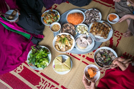 A traditional Vietnamese meal for lunar new year Tet holiday in spring, placed on new flowered sedge mat, on the last day of the last yearの写真素材