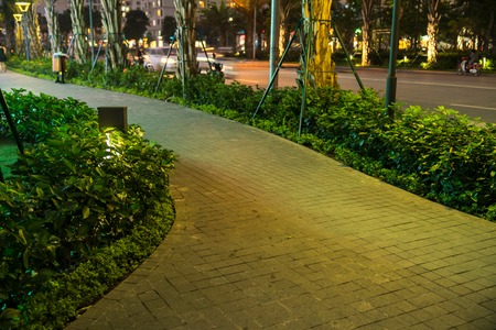Garden glowing decoration light in the park at night with walkway
