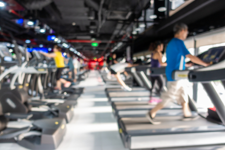 Blurred of fitness gym center interior background with two rows of cardio machineの写真素材