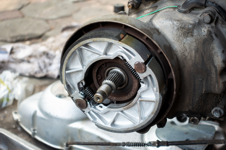 Old motorcycle drum brake pad in opened engine boxの写真素材