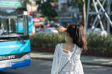 Young girl waiting for bus at bus station. Closeup.の写真素材