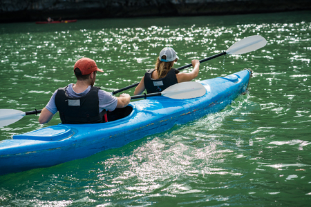 Tourists paddling kayak on Halong bay in Vietnam